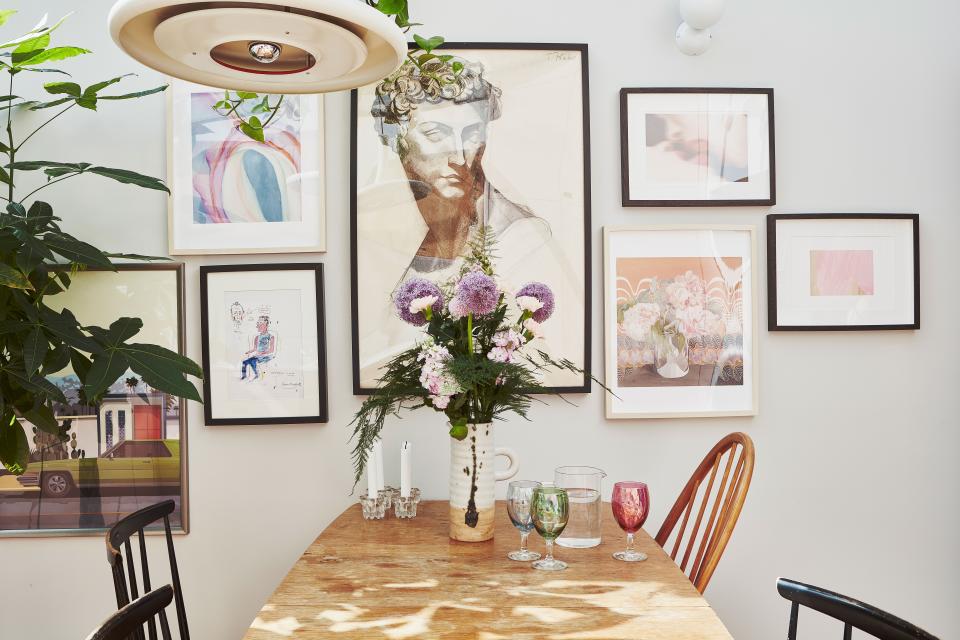 A smattering of artwork hangs above Rosie’s dining table. She isn’t embarrassed to confess that the California image is just the picture that came in the IKEA frame.