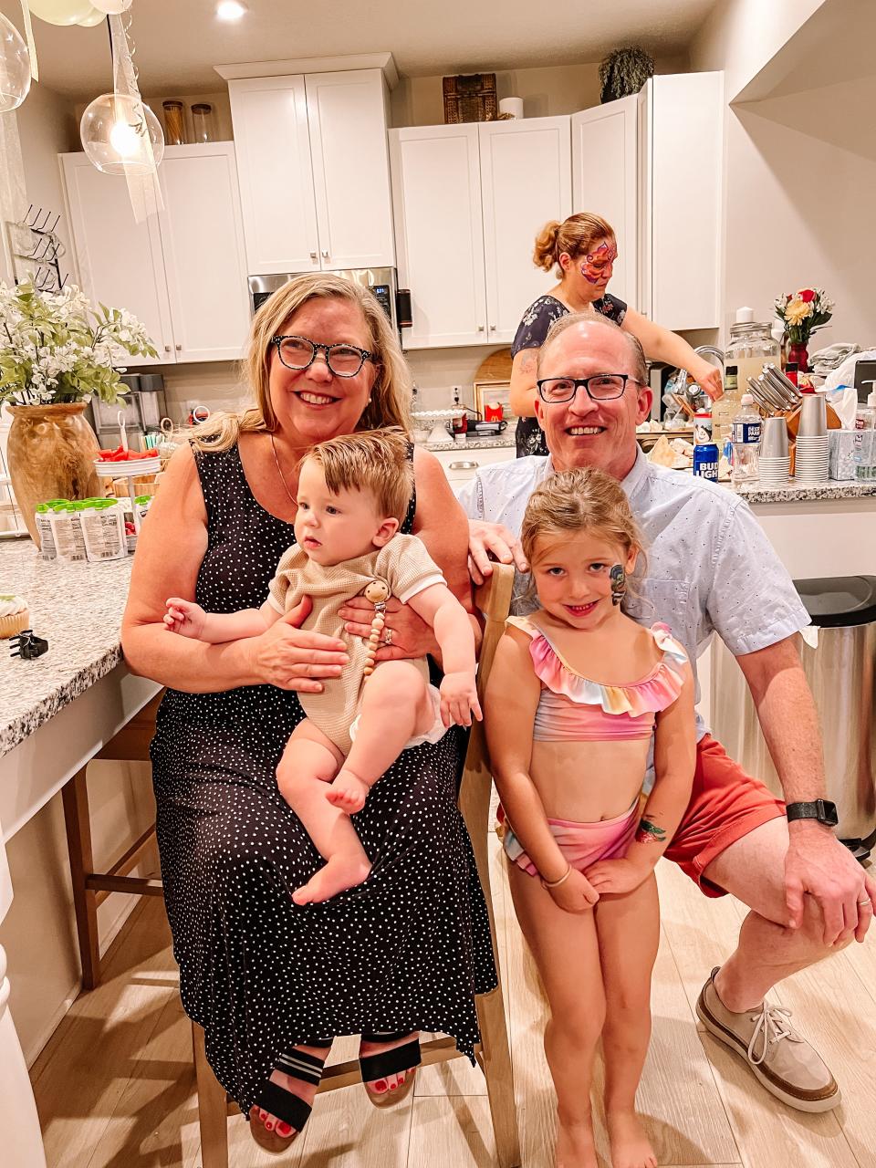 Grandma Lara and Grandpa Rich Wilson with Graham Horvath (being held) and LJ Horvath at her 5th birthday party.