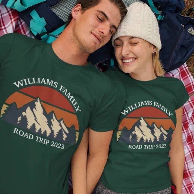 two models wearing matching green shirts that read "Williams family road trip 2023"