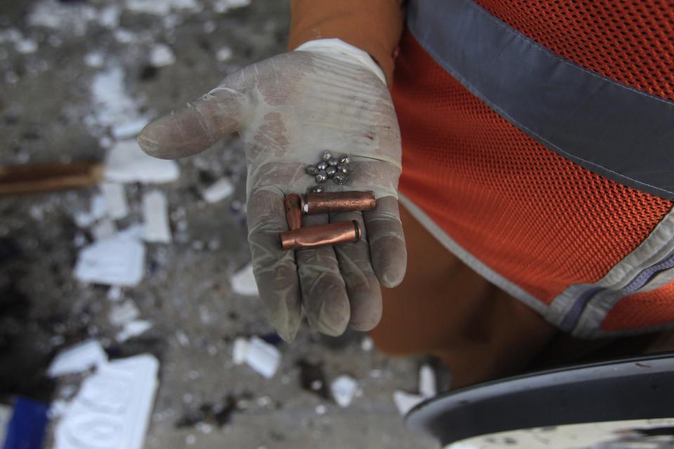 A rescue worker displays bullet casings and ball bearings collected from the site after an explosion in a Shi'ite mosque in Peshawar