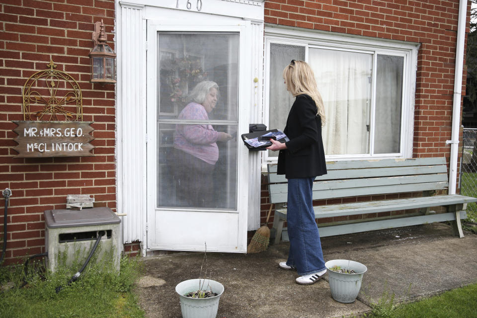 Transgender Mayoral candidate Rosemary Ketchum (right) speaks with registered voter Michele McClintock (left) while canvassing on Friday, April 5, 2024, in Wheeling, W.Va. (AP Photo/Kathleen Batten)