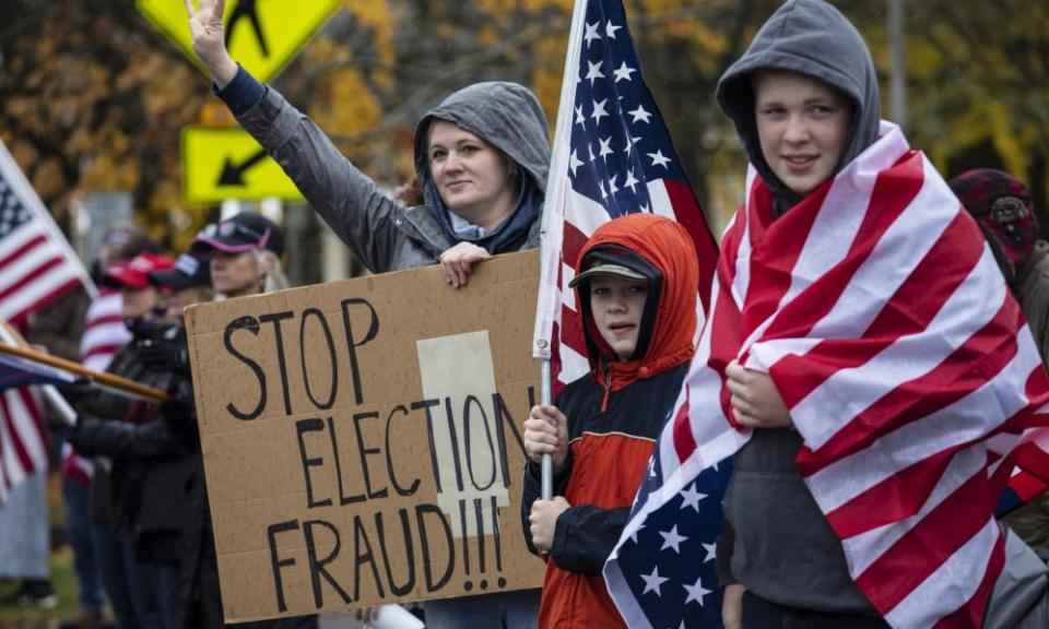 Trump supporters in Salem, Oregon, hold signs as they attend a ‘stop the steal’ rally against the outcome of the presidential election, in November.