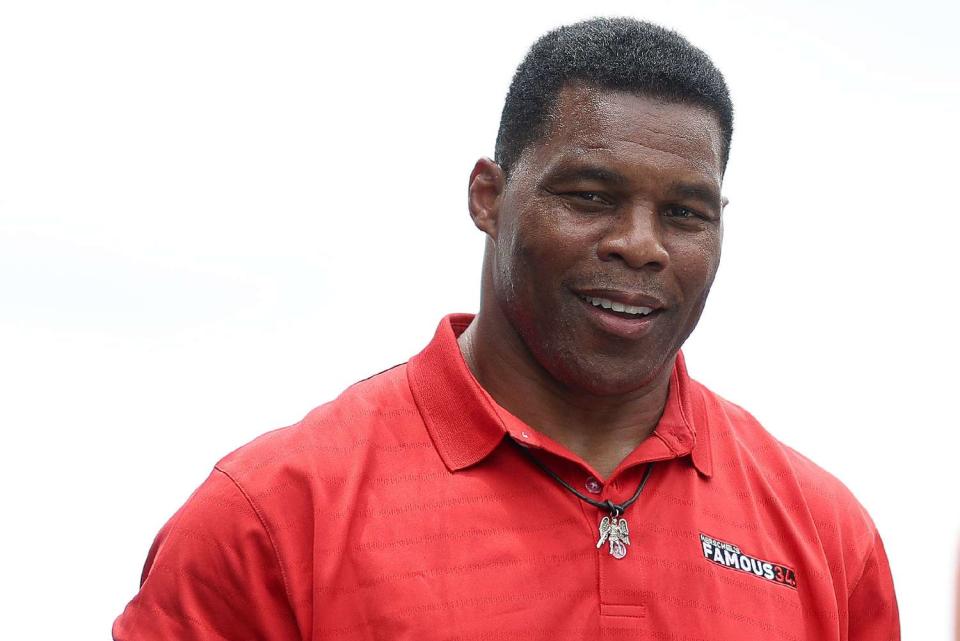 Republican candidate for US Senate Herschel Walker walks onstage during pre-race ceremonies prior to the NASCAR Cup Series Quaker State 400 at Atlanta Motor Speedway on July 10, 2022 in Hampton, Georgia.