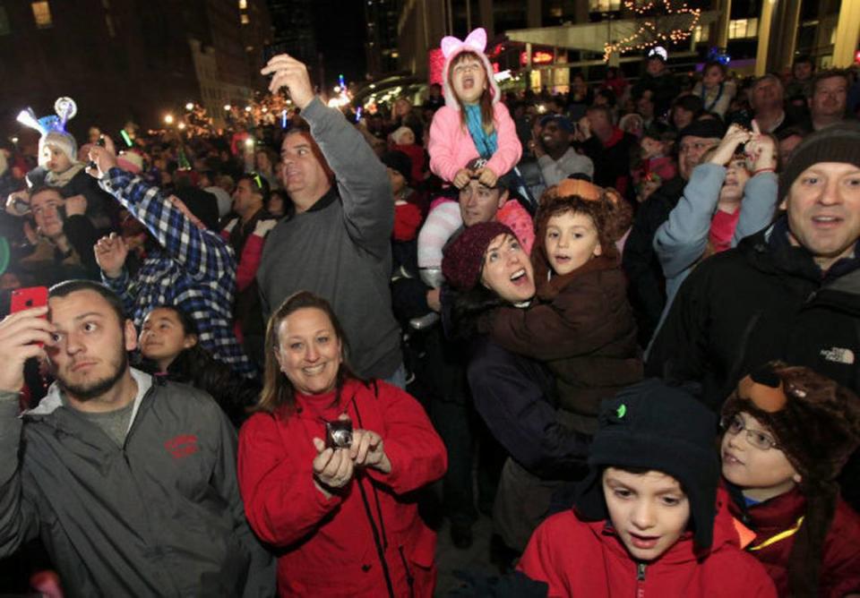 First Night Raleigh participants look up as the oversized acorn was lowered for the early countdown Monday, Dec. 31, 2012. tiwabu@newsobserver.com