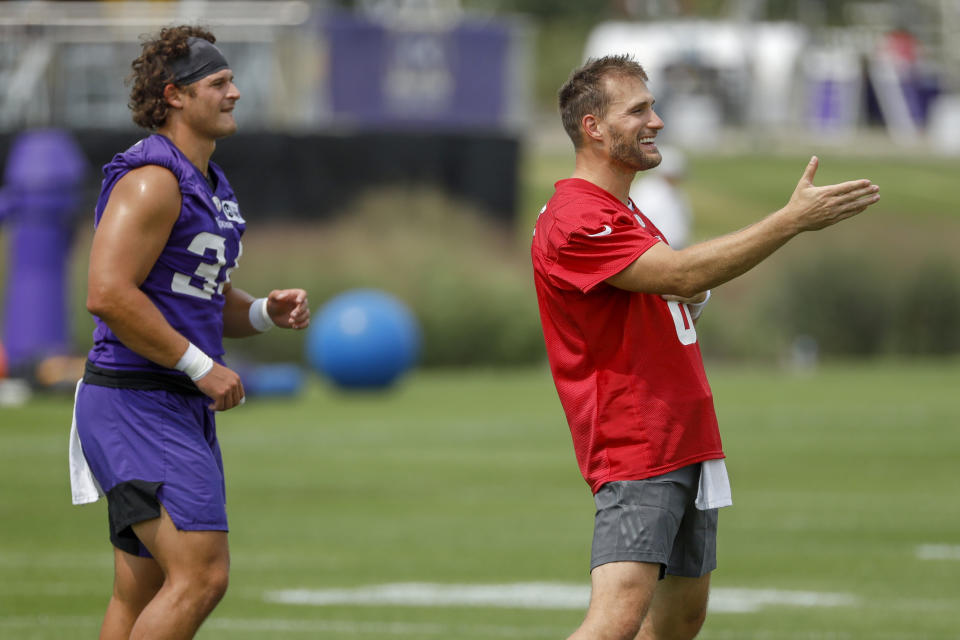 Minnesota Vikings quarterback Kirk Cousins, right, chats while arming up with Jake Bargas (34) during NFL training camp Wednesday, July 28, 2021, in Eagan, Minn. (AP Photo/Bruce Kluckhohn)