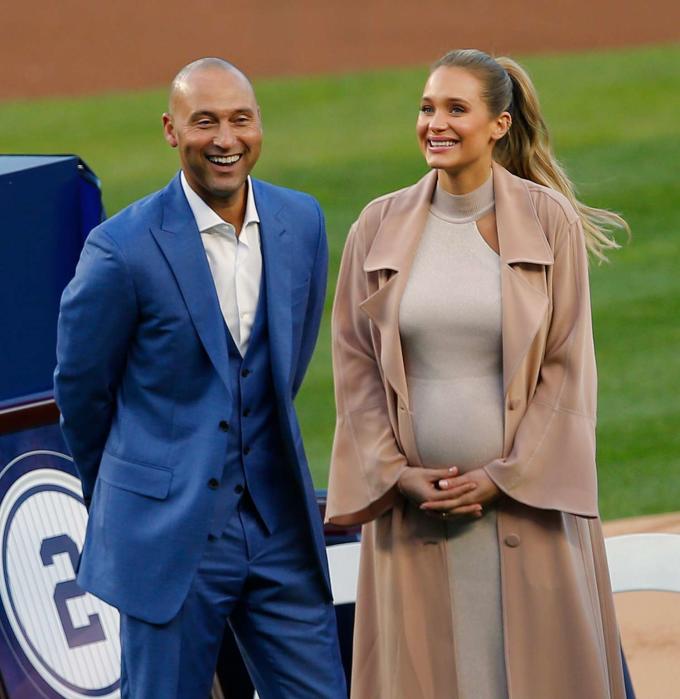 Derek Jeter and his wife Hannah pose in front of his plaque during a pregame ceremony honoring Jeter and retiring his number 2 at Yankee Stadium on May 14, 2017 in New York City