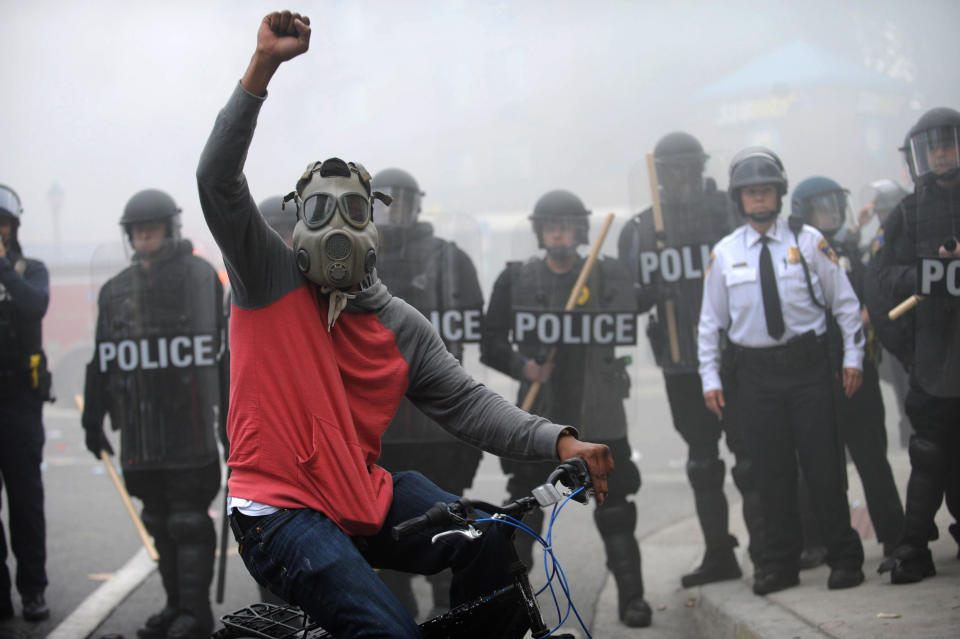 A protester rides his bike in front of a police line at North and Pennsylvania Avenues on Monday, April 27, 2015, Baltimore, MD, USA. Photo by Algerina Perna/Baltimore Sun/TNS/ABACAPRESS.COM