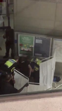 A still image from video shows responders attending to victim following acid attack in Stratford, London, Britain, September 23, 2017. @OFFICIALZAKVELI/Social Media/via REUTERS