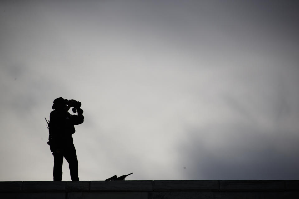 Security stands on the roof of the United Nations building during a visit by President Donald Trump, Monday, Sept. 24, 2018, at U.N. Headquarters. (AP Photo/Evan Vucci)
