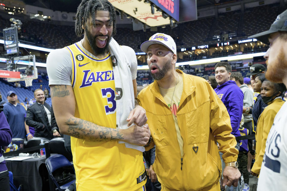 Los Angeles Lakers forward Anthony Davis (3) laughs after talking to his father, Anthony Davis, Sr., right, after defeating the New Orleans Pelicans in an NBA basketball game in New Orleans, Tuesday, March 14, 2023. (AP Photo/Matthew Hinton)