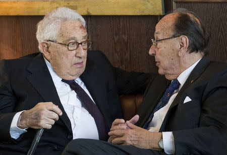 German former foreign minister Hans-Dietrich Genscher (R) and former U.S. Secretary of State Henry Kissinger speak during a reception for Kissinger's 90th birthday in Berlin, in this file picture taken June 11, 2013. REUTERS/Gero Breloer/Pool/Files