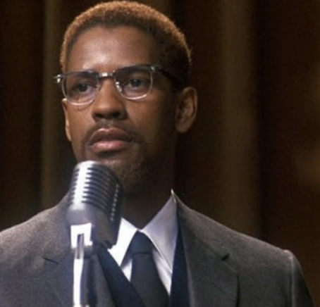 denzel in a suit and glasses