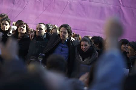 Spain's Podemos (We Can) party leader Pablo Iglesias (C) is embraced by party members after a party meeting in Madrid February 8, 2015. REUTERS/Juan Medina