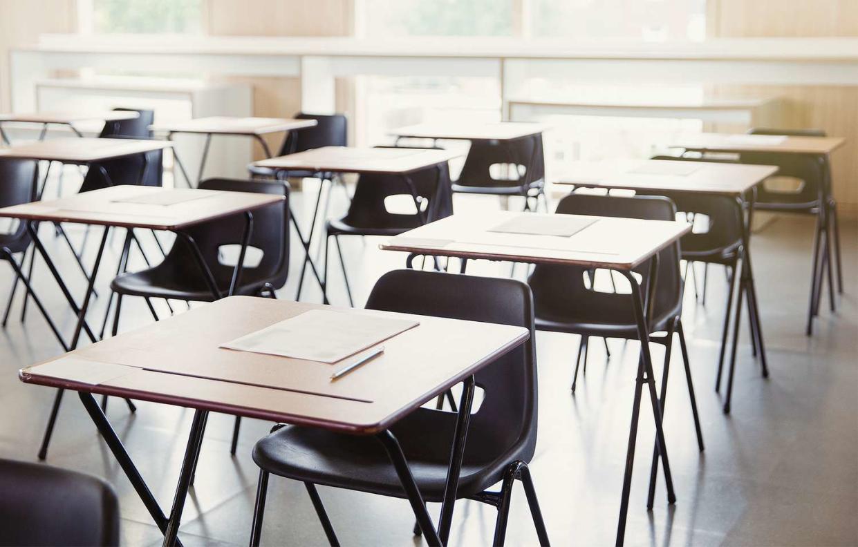 Tests on desks in empty classroom