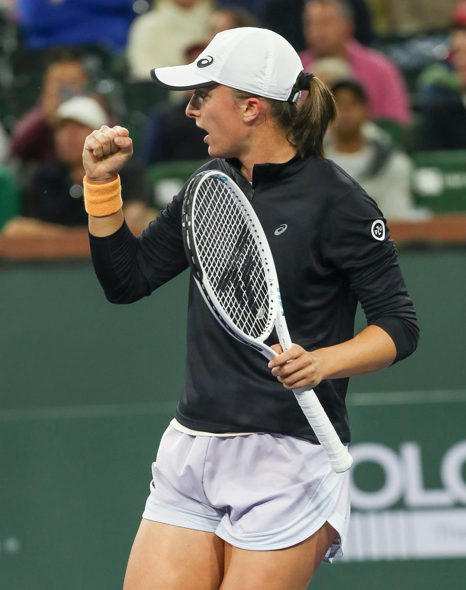 Iga Swiatek celebrates a point win during her match against Emma Raducanu at the BNP Paribas Open in Indian Wells, Calif., March 14, 2023. 