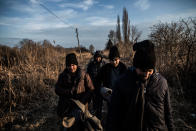 <p>Migrants from Pakistan walk their way towards Hungary following the railroad which takes from the Serbian town Subotica to the border, Feb. 2017. (Manu Brabo/MeMo) </p>