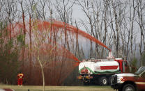 <p>A pumper truck sprays fire retardant on trees around the evacuated neighbourhood of Beacon Hill in Fort McMurray, Alta., on Wednesday, May 15, 2024. THE CANADIAN PRESS/Jeff McIntosh</p> 