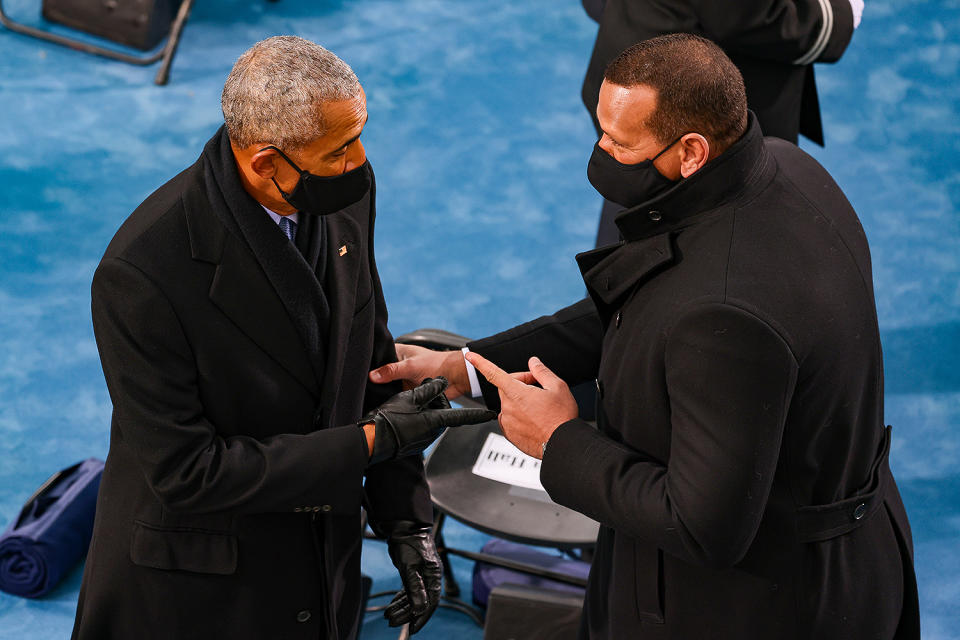 <p>Barack Obama and Alex Rodriguez — there to support his fiancée, performer Jennifer Lopez — shake hands as they arrive for the inauguration. </p>