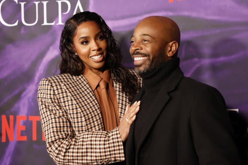 Kelly Rowland (R) and Tim Weatherspoon attend the New York premiere of "Mea Culpa" on Thursday. Photo by John Angelillo/UPI