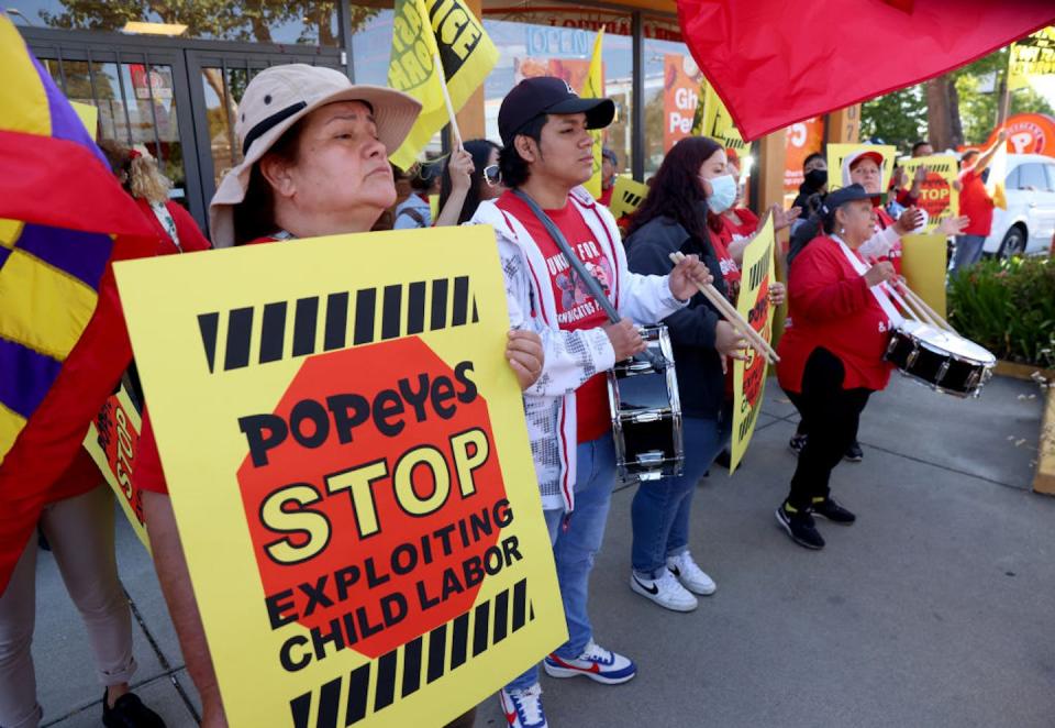 Workers protest outside a Popeye’s restaurant in Oakland, Calif., on May 18, 2023, after reports emerged of the franchise exploiting child labor. <a href="https://www.gettyimages.com/detail/news-photo/betty-escobar-left-and-other-fast-food-workers-protest-at-news-photo/1491552588?adppopup=true" rel="nofollow noopener" target="_blank" data-ylk="slk:Jane Tyska/Digital First Media/East Bay Times via Getty Images;elm:context_link;itc:0;sec:content-canvas" class="link ">Jane Tyska/Digital First Media/East Bay Times via Getty Images</a>