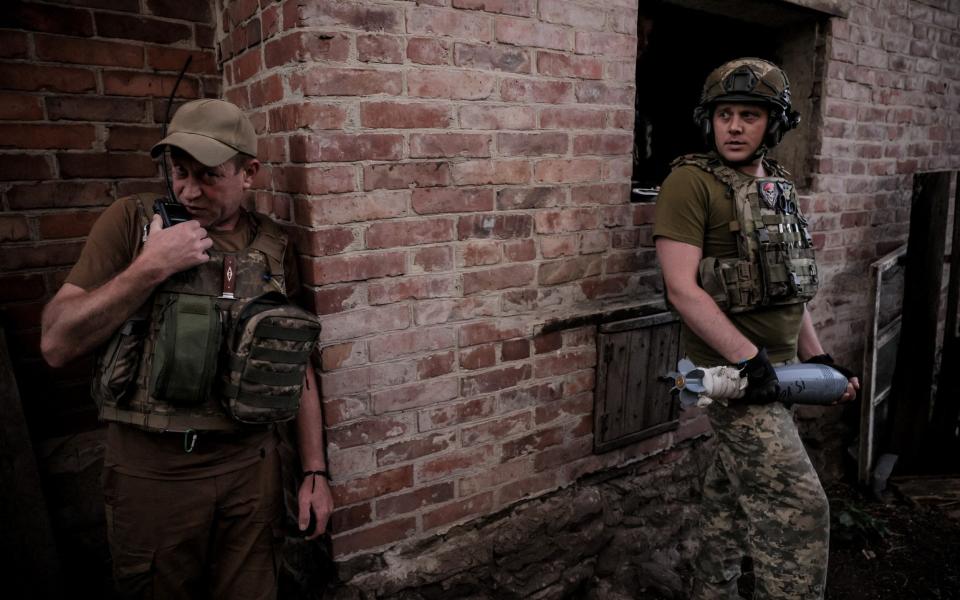 Soldiers of the 24th Mechanized Brigade prepare to fire a 120-mm mortar towards Russian troops