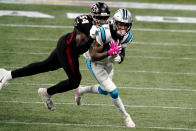 Carolina Panthers wide receiver Robby Anderson (11) is wraped up by Atlanta Falcons linebacker Foye Oluokun (54) during the first half of an NFL football game, Sunday, Oct. 11, 2020, in Atlanta. (AP Photo/Brynn Anderson)