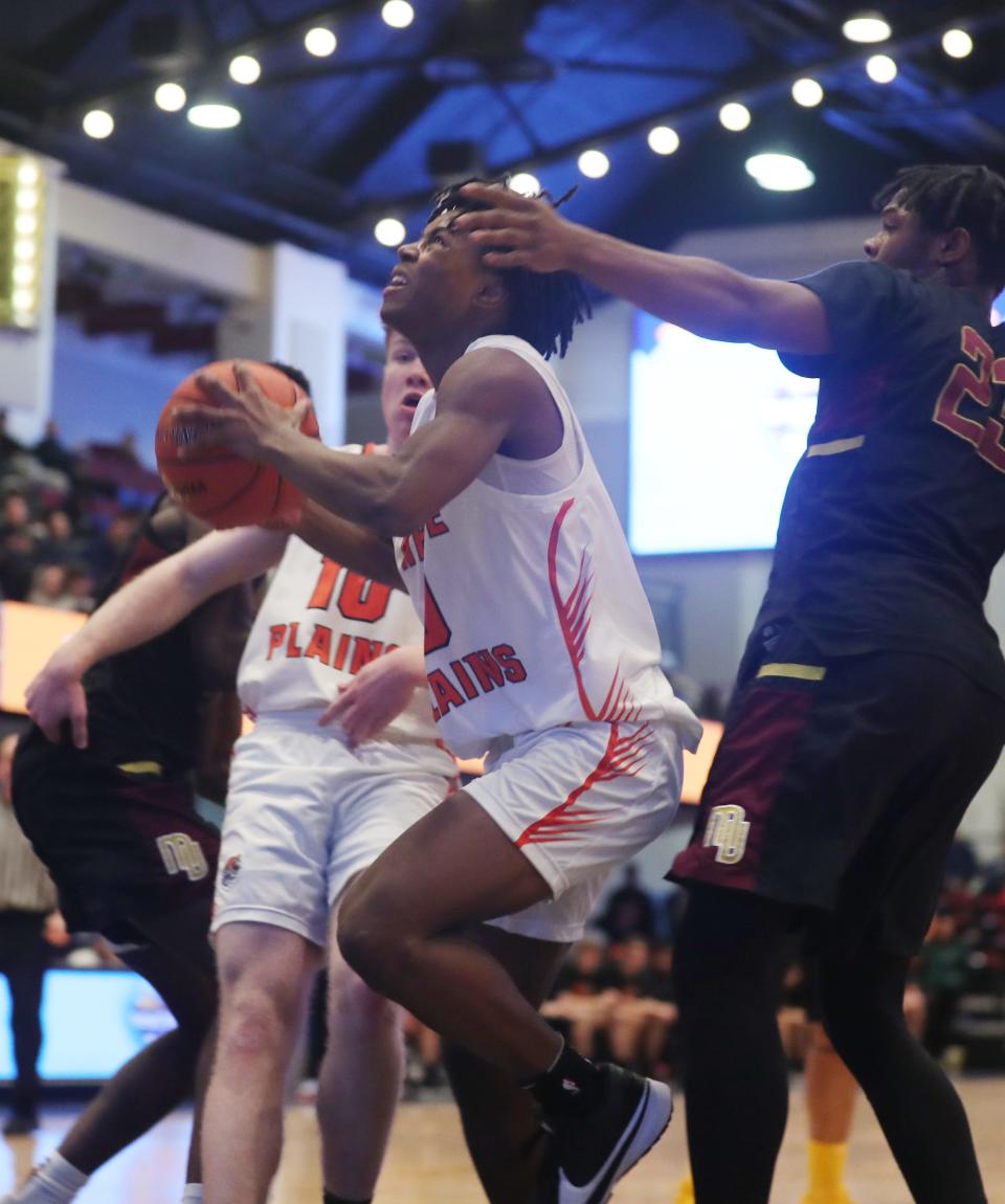 White Plains Miles Johnson drives to the basket against Mt. Vernon during the Section 1 Class AAA semifinal at the Westchester County Center in White Plains Feb. 28, 2024.