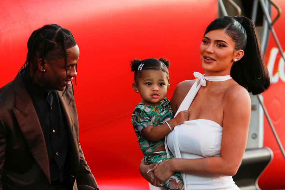 Travis Scott, Kylie Jenner and their daughter Stormi Webster share a moment at the premiere for the documentary 