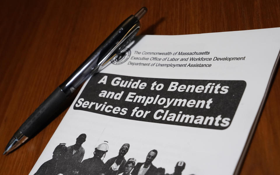 A booklet describing unemployment benefits is seen on a desk, Thursday, Nov. 5, 2020, in North Andover, Mass. Unemployment drops to 6.9% but US job growth slows again to 638,000 in face of surging pandemic (AP Photo/Elise Amendola)