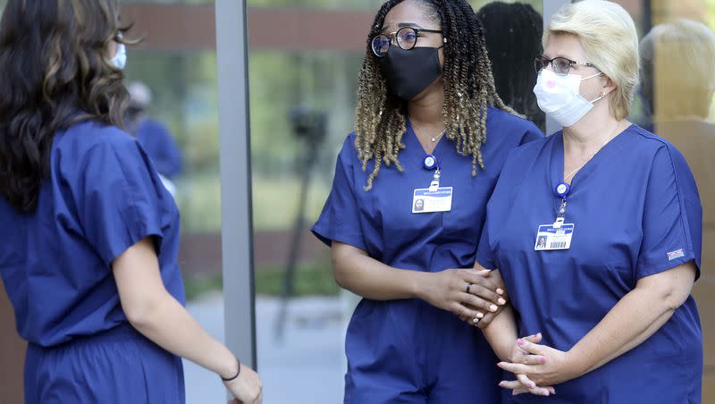 Shereyah Barbera, a registered nurse from New York’s Northwell Health, left, approaches Annice Sterling and Magdalena Litwinczuk, both registered nurses with Northwell Health, after speaking at a press conference at the Intermountain Transformation Center in Murray on Tuesday, Aug. 4, 2020. One-third of U.S. nurses are planning to quit according to a recent survey.