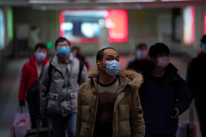 People wearing masks are seen at a subway station in Shanghai