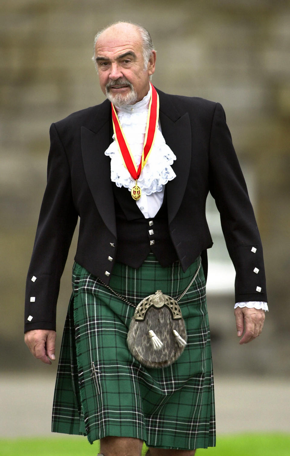 Connery wears full Highland dress and his medal after he was formally knighted by the queen in July 2000. (Photo: David Cheskin/PA Archive)
