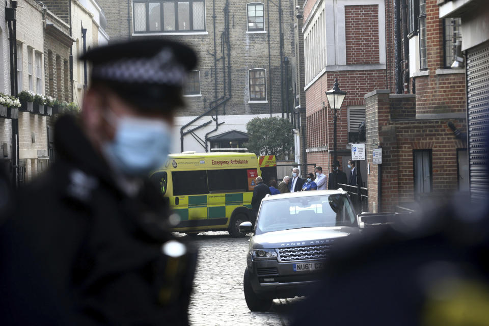 Members of hospital staff, security and police officers attend as an ambulance moves outside the rear of the King Edward VII Hospital in London where Prince Philip is being treated Monday March 1, 2021. (Dominic Lipinski/PA via AP)