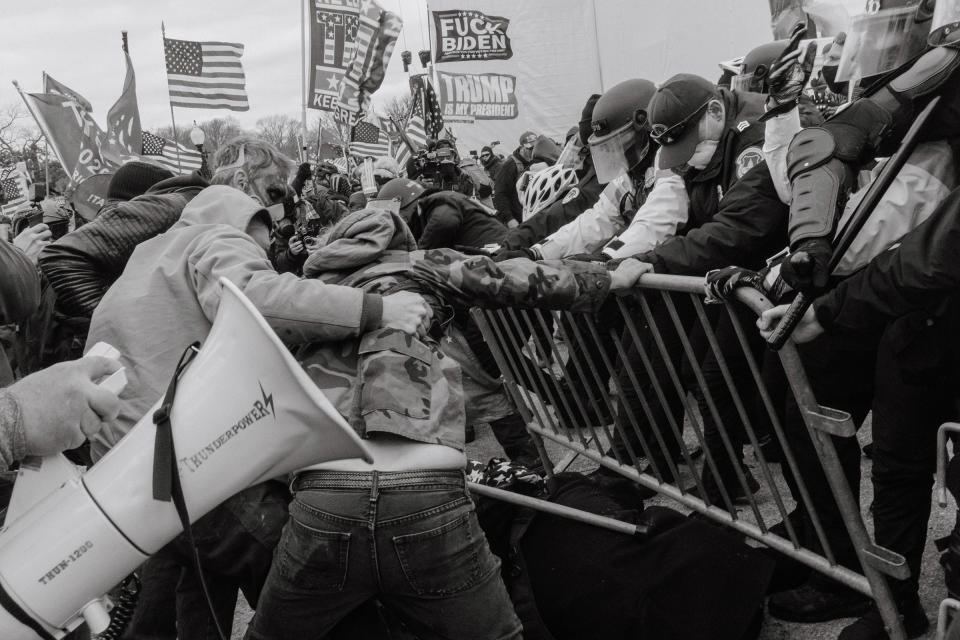 Pro-Trump rioters push through a barrier outside of the Capitol building..<span class="copyright">Christopher Lee for TIME</span>