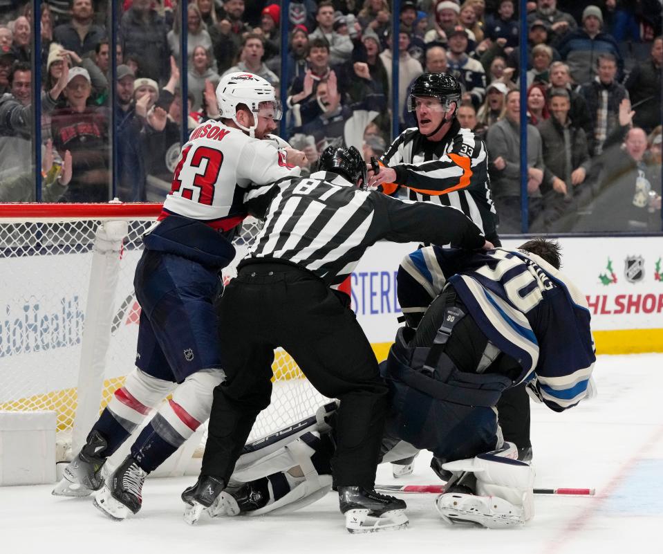 Dec. 201, 2023; Columbus, Ohio, USA; 
Washington Capitals right wing Tom Wilson (43) and Columbus Blue Jackets goaltender Elvis Merzlikins (90) are separated after fighting during overtime at Nationwide Arena on Thursday.