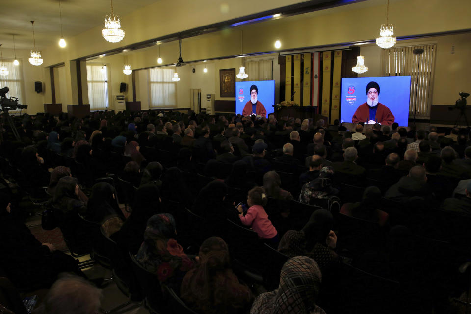 Supporters of the Iranian-backed Hezbollah group listen to a speech of Hezbollah leader Sayyed Hassan Nasrallah, via a video link, in a southern suburb of Beirut, Lebanon, Friday, March 8, 2019. Nasrallah called on his supporters to donate funds to the group as it comes under tighter sanctions from western countries. (AP Photo/Bilal Hussein)