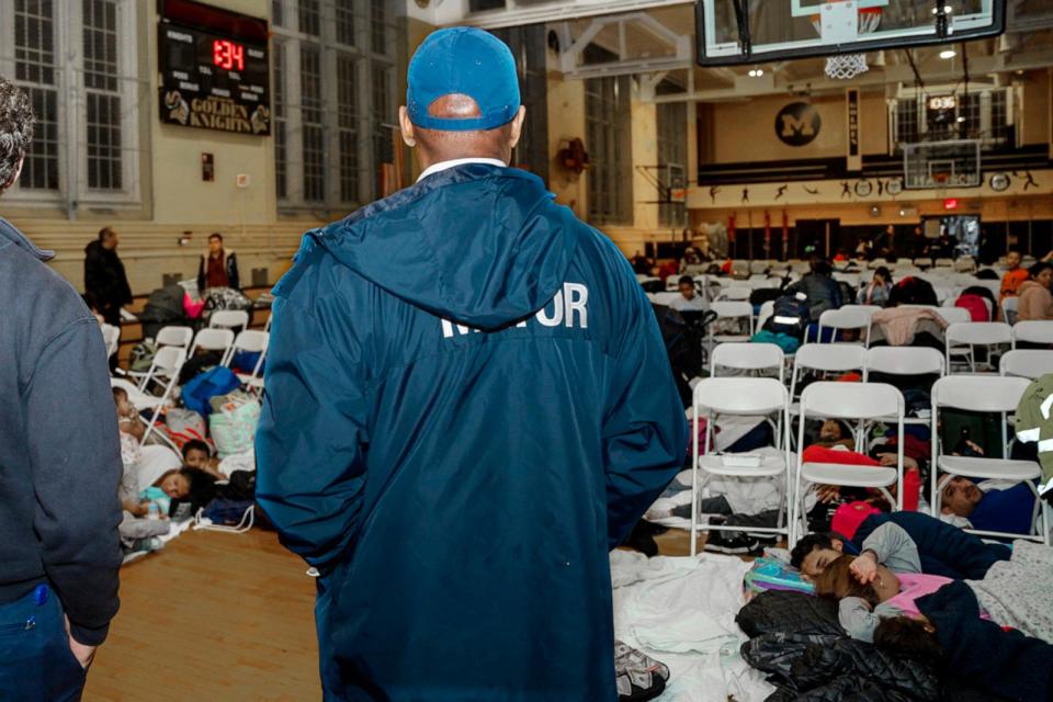 PHOTO: New York Mayor Eric Adams visits with asylum seekers taking shelter at James Madison High School, in the Brooklyn borough of New York, Jan. 9, 2024.  (Benny Polatseck/AP)