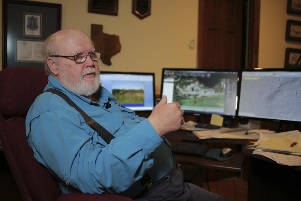 Geologist Richard Howe sits at his home office in suburban Houston, Tuesday, April 11, 2023, as he discussed the history of a sinkhole in Daisetta, Texas. Earlier this month, Daisetta officials announced the sinkhole, which had first emerged in 2008 but had been dormant since then, had started to again expand. Officials say they're monitoring the new growth and keeping residents informed. (AP Photo/Lekan Oyekanmi)