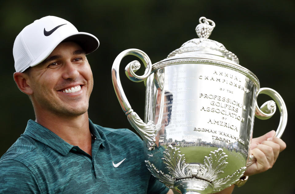 FILE - In this Aug. 12, 2018, file photo, Brooks Koepka holds the Wanamaker Trophy after he won the PGA Championship golf tournament at Bellerive Country Club, in St. Louis. Koepka has won PGA Tour player of the year on the strength of his two major championships. (AP Photo/Brynn Anderson, File)