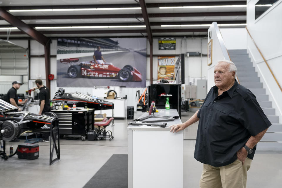 A.J. Foyt watches as crew members work inside his racing team's garage, Wednesday, March 29, in Waller, Texas. Foyt was retired when he suffered two near-fatal attacks by killer bees, one sending him into shock. He once flipped a bulldozer into a pond on one of his Texas properties, emerging to shout: “I ain’t no Houdini! I needed some air!” He has had several staph infections, one leading to a concrete spacer in his leg that eventually led to an artificial knee. (AP Photo/Godofredo A. Vásquez)