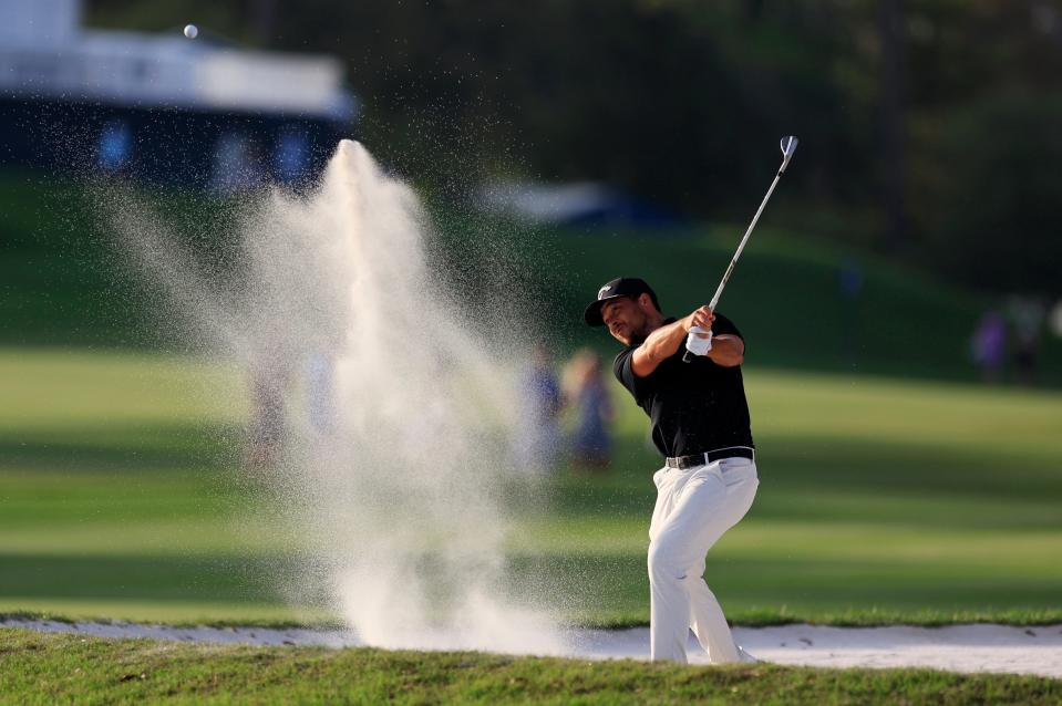 Xander Schauffele plays a shot from a bunker on the 16th hole during the third round of The Players Championship on Saturday at the Players Stadium Course at TPC Sawgrass. Schauffele finished atop the leader board at 17 under par and Wyndham Clark in second at 16 under par.