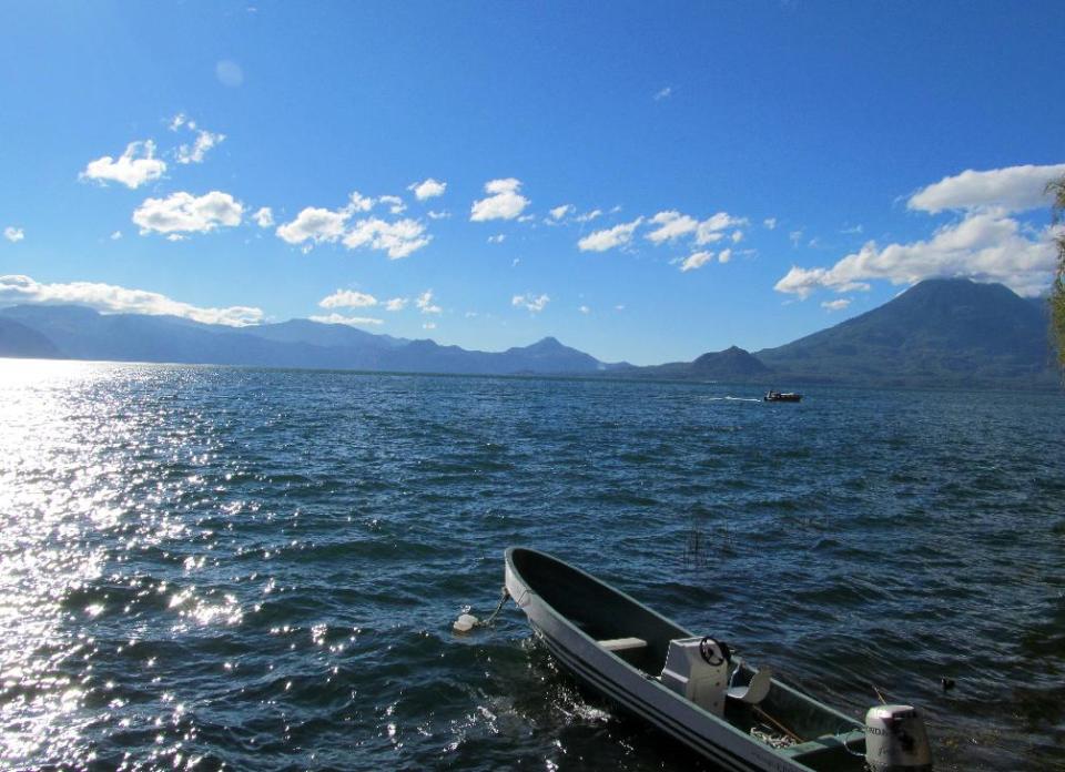 This February 2013 photo shows Lake Atitlan, in Guatemala's western highlands, surrounded by volcanoes Tomilan and Atitlan. Tourists can spend a day shuttling on local boats between the lake's small towns, each of which has a particular character. (AP Photo/Amir Bibawy)