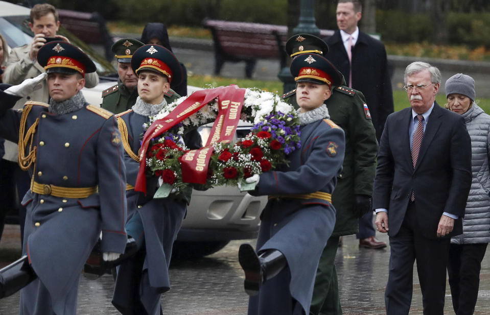 U.S. National Security Adviser John Bolton, second from right, arrives for a wreath laying ceremony at the Tomb of the Unknown Soldier by the Kremlin wall in Moscow, Russia, Tuesday, Oct. 23, 2018. U.S. President Donald Trump's national security adviser Bolton struck a conciliatory note Tuesday in talks in Moscow, just days after Trump vowed to pull out of a key arms control treaty with Russia. (Sergei Karpukhin/Pool Photo via AP)