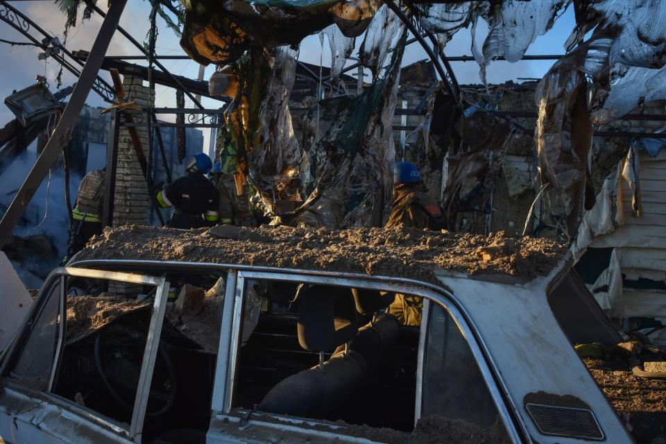 Members of the Ukrainian State Emergency Service clear the rubble at the building which was destroyed as a result of Russian strike in Zaporizhzhia district, Ukraine, Friday, March 31, 2023 (AP)