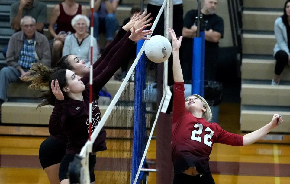 Coventry's Olivia Fornuto is blocked by East Greenwich's Ella Johnson and Melissa Kocak as she tries to tip the ball over the net in Thursday's match.