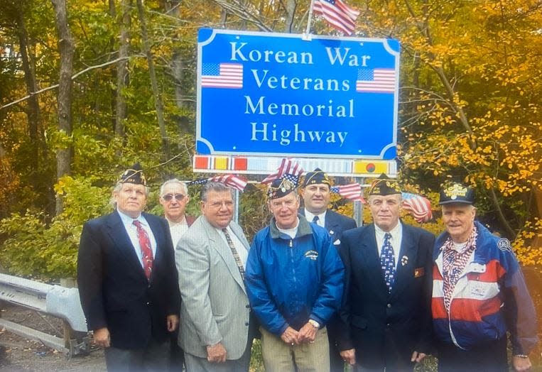 The late state Senator Anthony R. Bucco, third from left, and Warren Wilhide, right, with Wilhide's fellow veterans (from left): Joe Notowicz, Anthony Romano, Bob Tracey, John Viola and Tony Neggers, at a sign on Route 287 near Morristown designating the interstate as the Korean Veterans Memorial Highway.