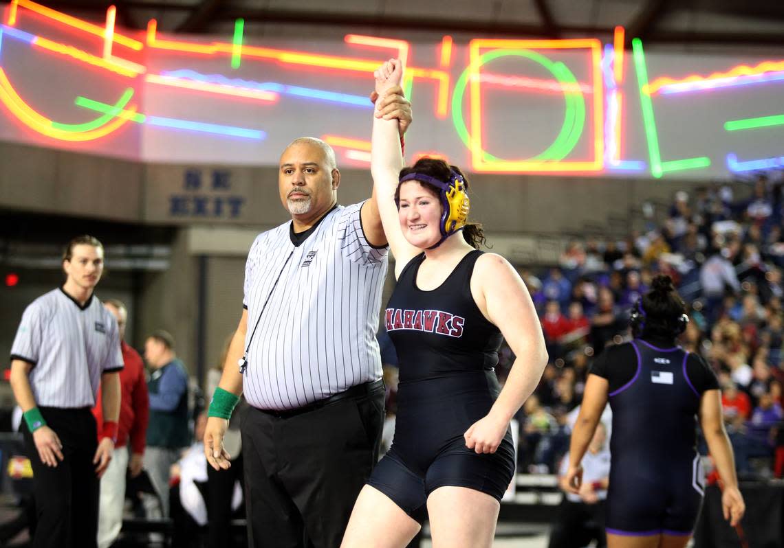 Marysville-Pilchuck’s Alivia White is all smiles as her arm is raised after ;inning Connell’s Rosa Saucedo-Ramirez in their championship match at Mat Classic XXXII in the Tacoma Dome on Saturday, Feb. 22, 2020 in Tacoma, Wash. (Andy Bronson / The Herald)
