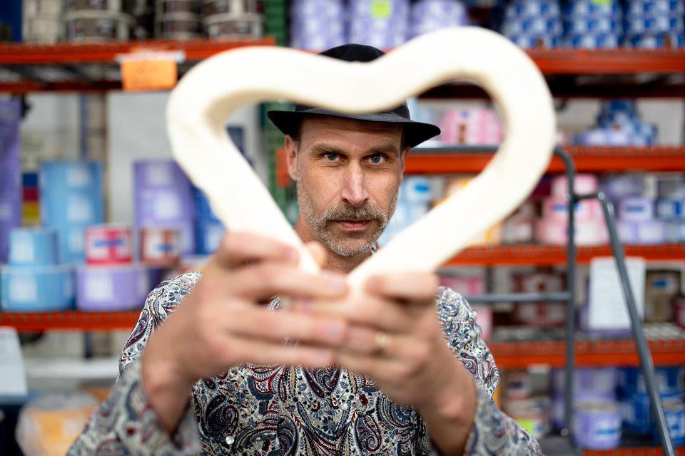 David Bronner bends a bar of soap into the shape of a heart at the Dr. Bronner’s factory in Vista, California. 