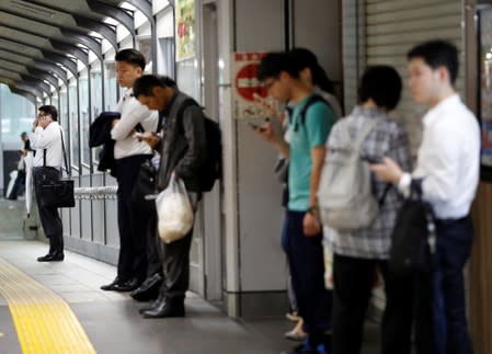 Passengers wait for the resumption of train service in a snarl caused by Typhoon Faxai at Komagome station in Tokyo