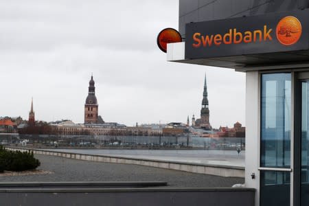 Swedbank signs are seen on the bank's Latvian head office in Riga